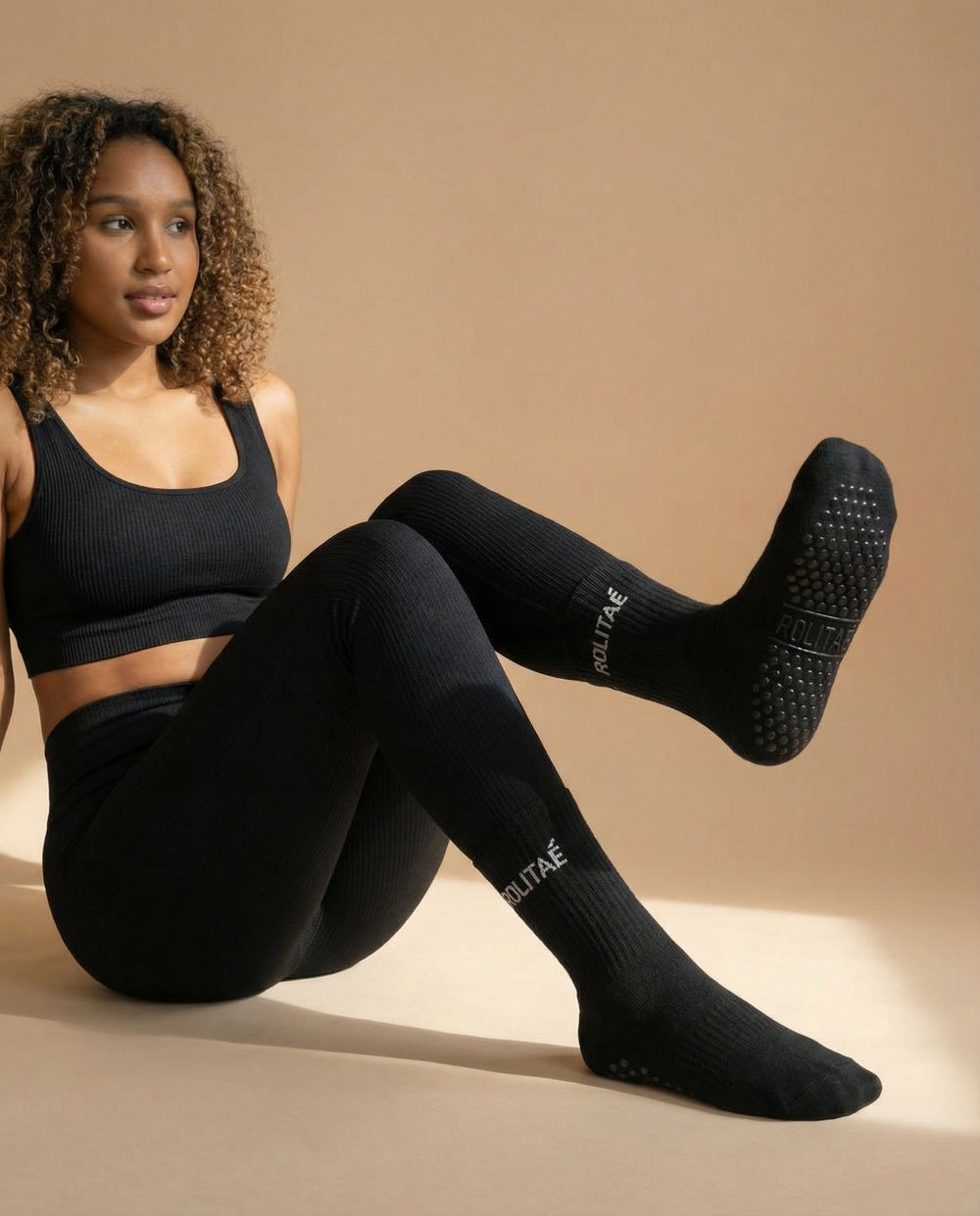 rolitae influencer wearing black pilates socks
